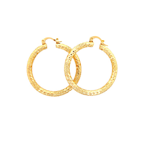 The Beautiful Texturized Hoops Earrings, measuring 4cm and made from 14k gold-filled material, are artfully displayed against a pristine white background. These elegant earrings are perfect for sensitive ears as they are lead and nickel-free.